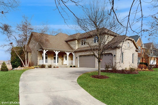 view of front of home featuring a porch, a garage, and a front yard