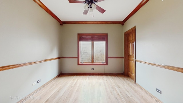 empty room featuring ceiling fan, ornamental molding, and light wood-type flooring