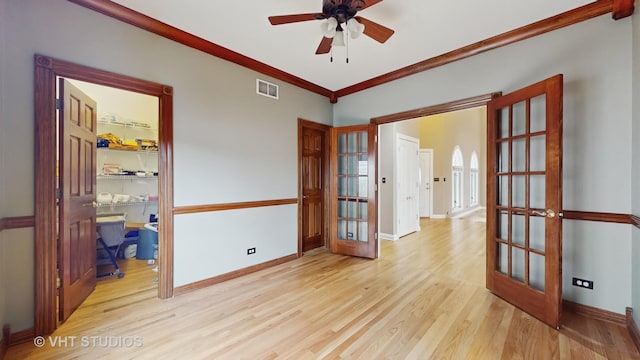 spare room with light hardwood / wood-style flooring, ornamental molding, french doors, and ceiling fan