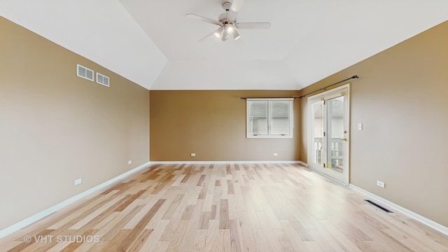 empty room featuring ceiling fan, lofted ceiling, and light hardwood / wood-style flooring