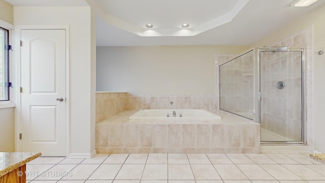 bathroom featuring a raised ceiling, vanity, shower with separate bathtub, and tile patterned floors