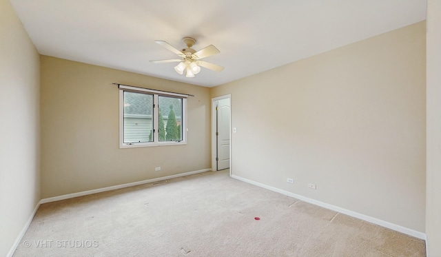 carpeted spare room with ceiling fan