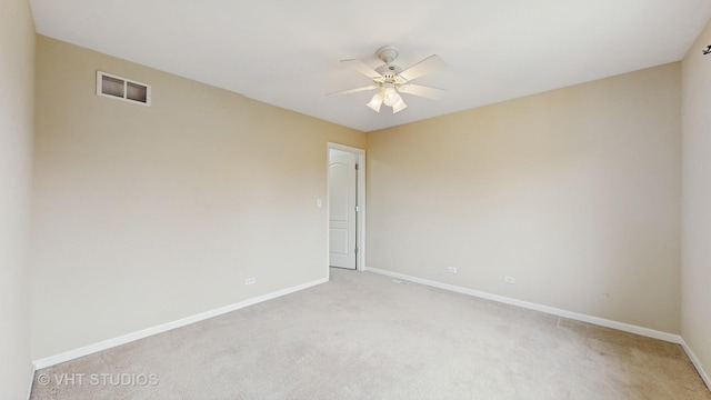 carpeted spare room featuring ceiling fan