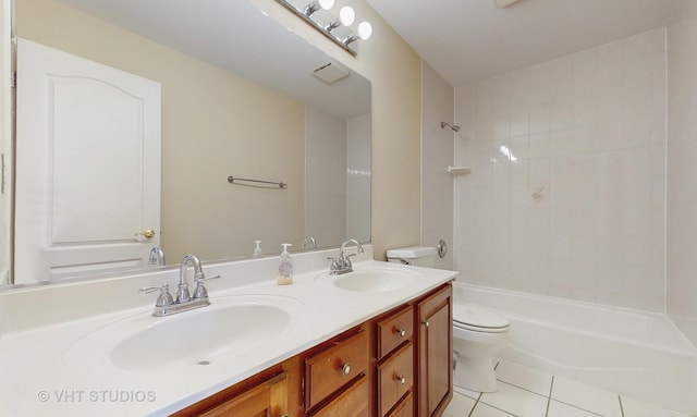 full bathroom with tiled shower / bath, vanity, toilet, and tile patterned flooring