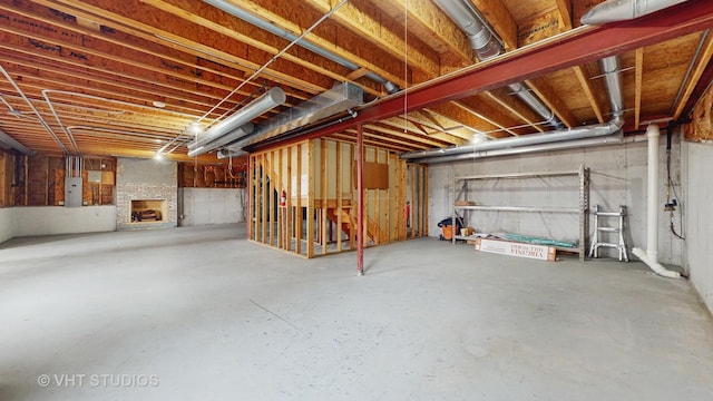 basement featuring a fireplace and electric panel