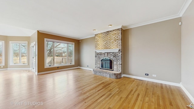 unfurnished living room with crown molding, a fireplace, and light hardwood / wood-style floors