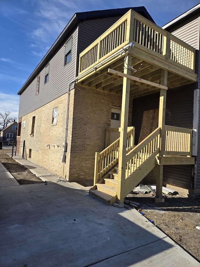 view of side of home featuring a balcony