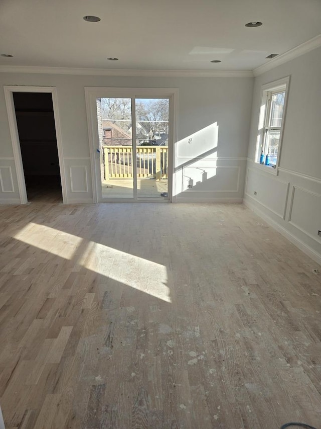 spare room with crown molding and wood-type flooring