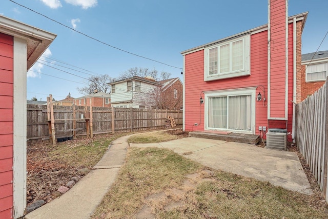 back of house with central AC and a patio area