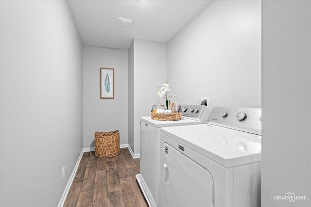 laundry area featuring dark wood-type flooring and washing machine and clothes dryer