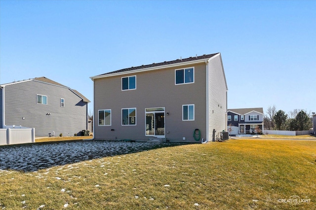 rear view of house with cooling unit and a yard