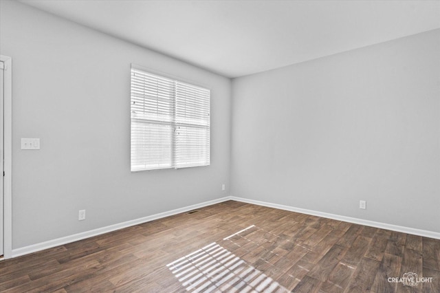 spare room with dark hardwood / wood-style floors