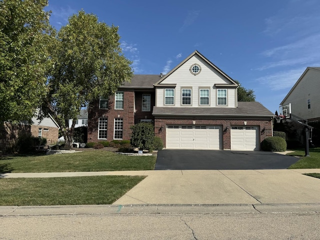 view of front property with a garage and a front yard