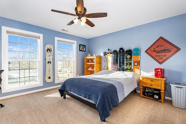 bedroom featuring ceiling fan and carpet