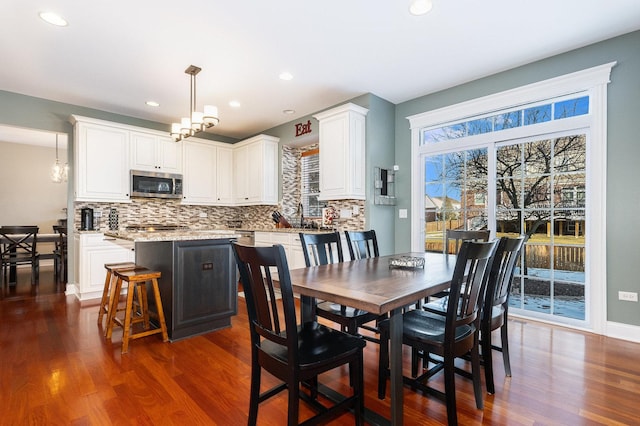 dining space featuring dark hardwood / wood-style floors and a chandelier