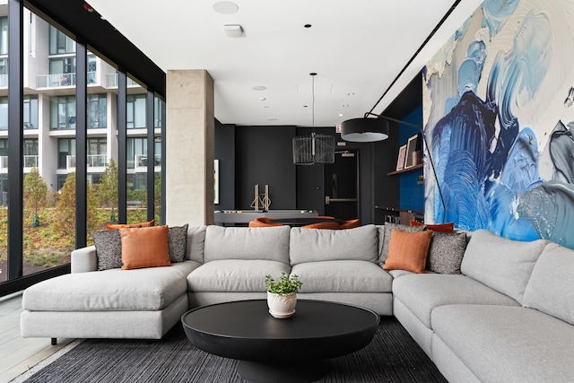 living room with an inviting chandelier and a wall of windows