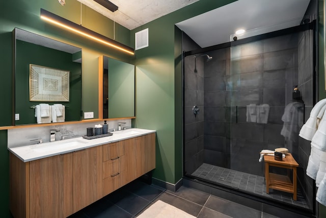 bathroom featuring vanity, tile patterned floors, and walk in shower