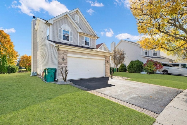 view of front facade with a garage, cooling unit, and a front lawn