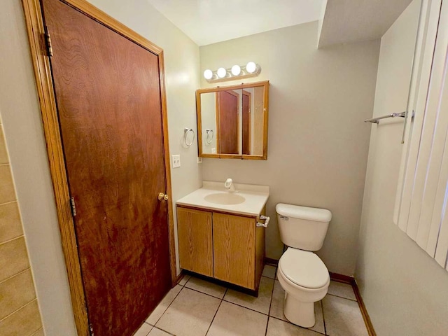 bathroom featuring vanity, tile patterned floors, and toilet