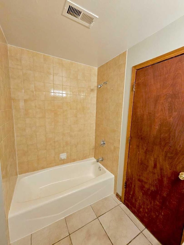 bathroom with tile patterned flooring and tiled shower / bath combo