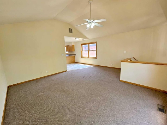 interior space with lofted ceiling, light colored carpet, and ceiling fan