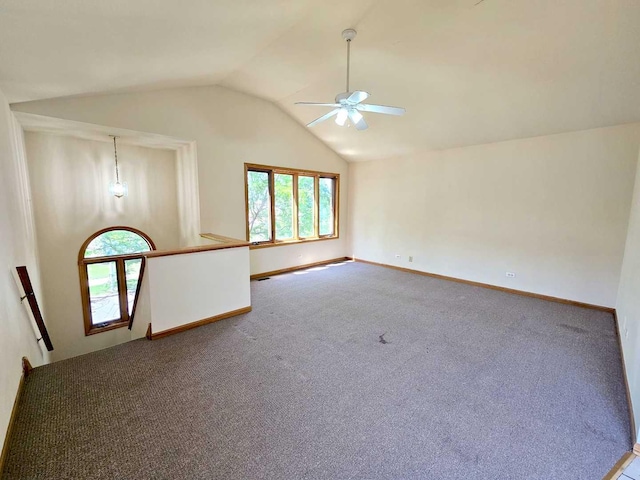 carpeted empty room with lofted ceiling, plenty of natural light, and ceiling fan