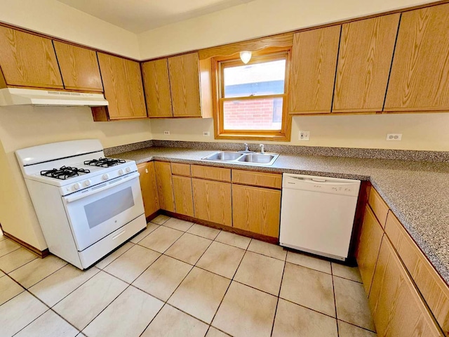 kitchen with white appliances, sink, and light tile patterned floors