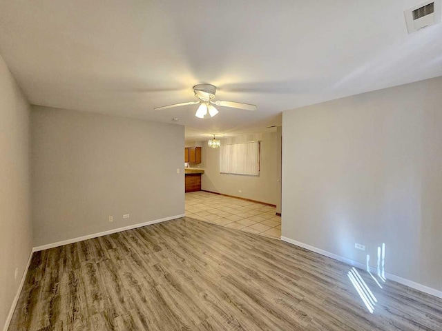 unfurnished room with ceiling fan and light wood-type flooring