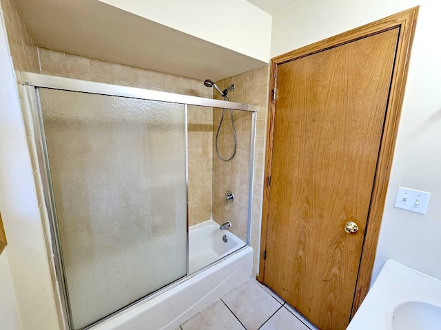 bathroom with sink, tile patterned floors, and combined bath / shower with glass door