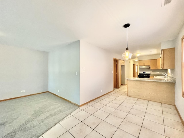 kitchen featuring sink, hanging light fixtures, light brown cabinets, kitchen peninsula, and stove