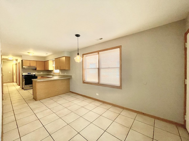 kitchen with light tile patterned flooring, pendant lighting, stainless steel stove, light brown cabinetry, and kitchen peninsula