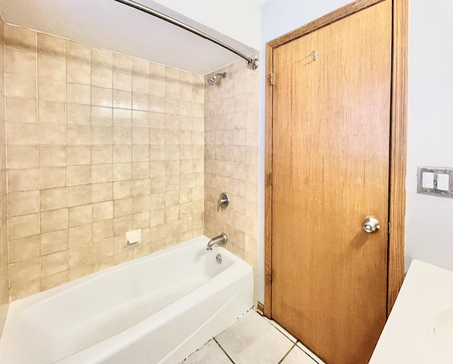 bathroom featuring tiled shower / bath combo and tile patterned floors