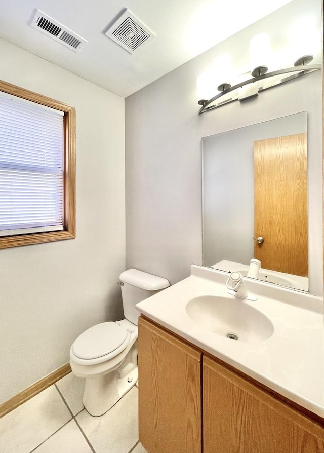 bathroom featuring vanity, toilet, and tile patterned flooring