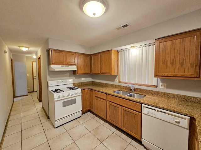 kitchen featuring light tile patterned flooring, sink, and white appliances