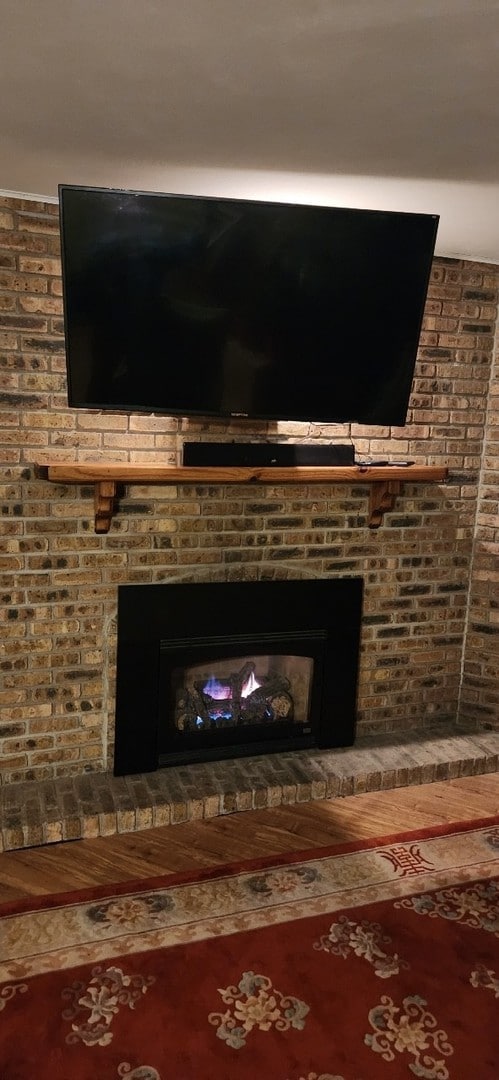 interior details with a brick fireplace