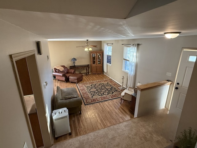 living room with hardwood / wood-style flooring and ceiling fan