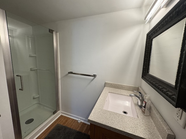 bathroom with vanity, hardwood / wood-style floors, and walk in shower