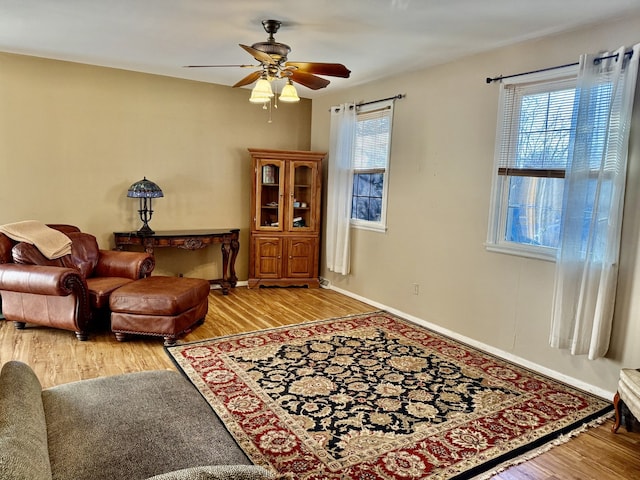 living area with plenty of natural light, ceiling fan, and light wood-type flooring