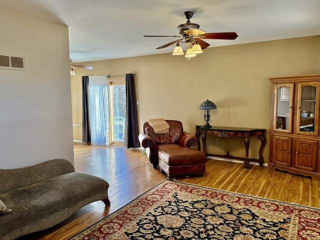 living room with ceiling fan and light hardwood / wood-style floors