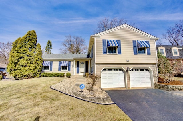 tri-level home featuring a garage, driveway, and a front yard