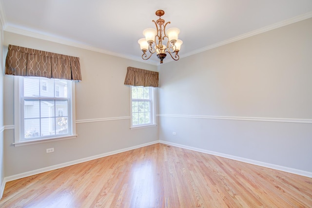 unfurnished room with baseboards, an inviting chandelier, wood finished floors, and crown molding