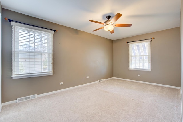 empty room featuring visible vents, ceiling fan, baseboards, and carpet floors