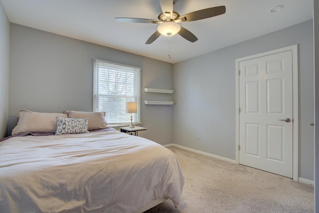 bedroom featuring light carpet, ceiling fan, and baseboards