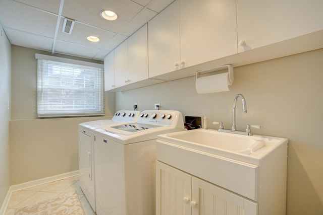 laundry room with recessed lighting, cabinet space, light tile patterned floors, baseboards, and washing machine and clothes dryer