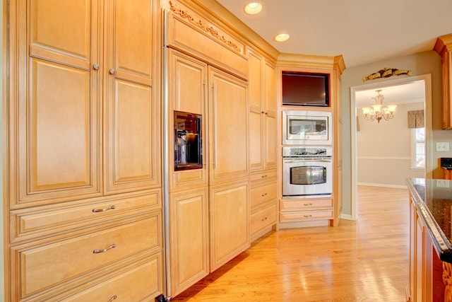 kitchen featuring dark stone countertops, recessed lighting, stainless steel appliances, light wood-style floors, and baseboards