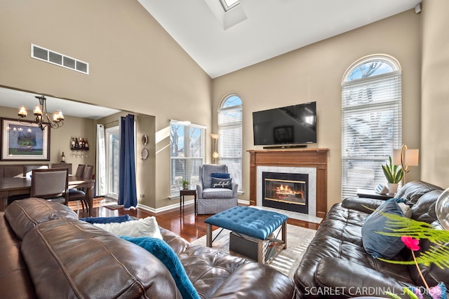 living room with hardwood / wood-style flooring, a fireplace, high vaulted ceiling, and a wealth of natural light