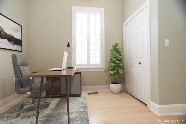 office area with visible vents, wood finished floors, and baseboards