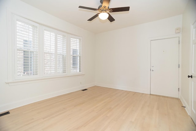 unfurnished room featuring visible vents, ceiling fan, light wood-type flooring, and baseboards