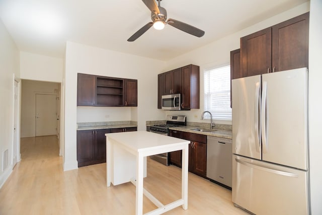 kitchen with open shelves, a sink, stainless steel appliances, light countertops, and dark brown cabinets