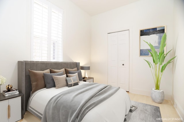 bedroom with a closet and baseboards